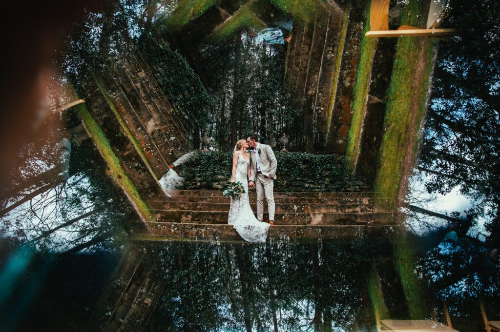 husband and wife kiss in gardens with prism effect