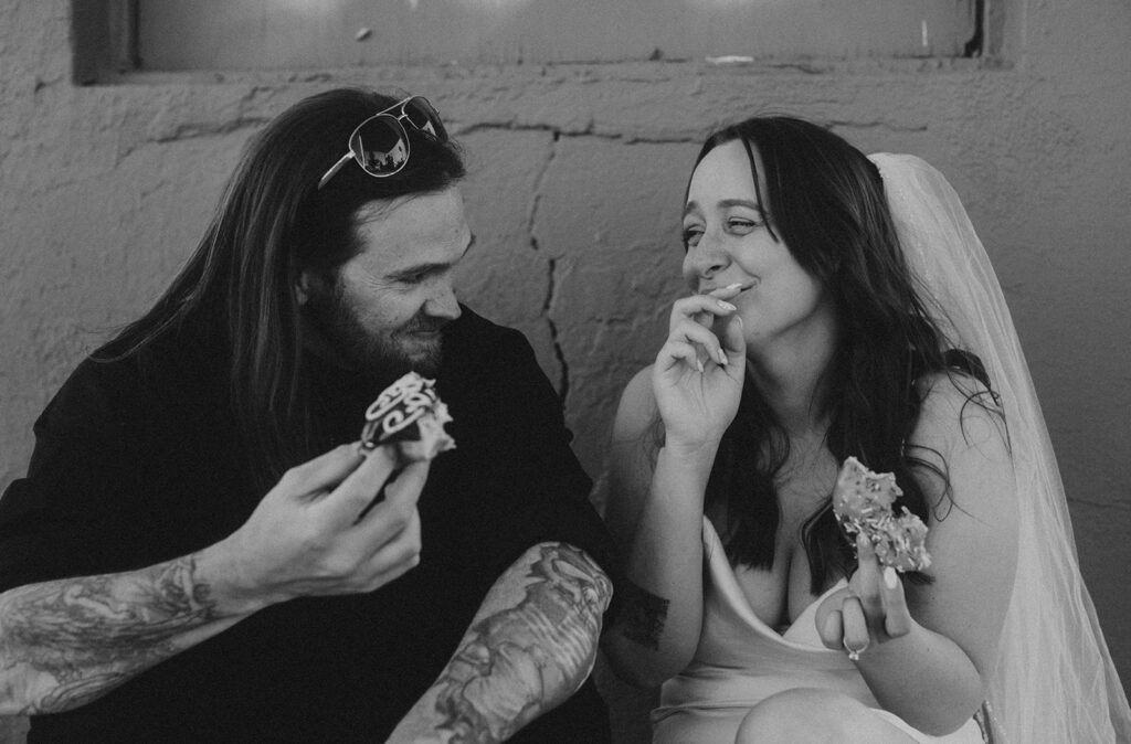 bride and groom in las vegas eat a donut